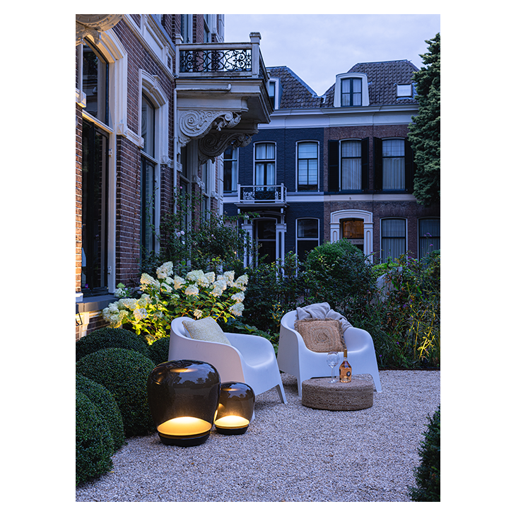 Big and little Voque light beside chairs.