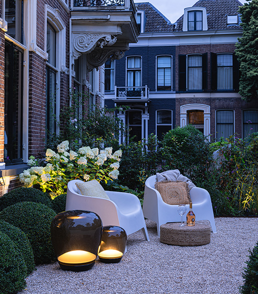 Big Voque sitting on gravel in backyard