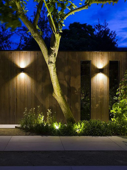 in-lite Halo Up-Down 100-230V light, fence mounted, illuminating pathway.