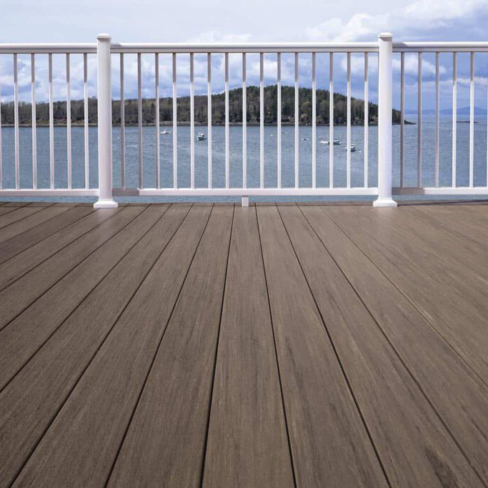 deck with white railing looking out at a lake