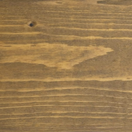 gold tone finish cutek sample on brown pressure treated lumber