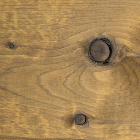 gold tone finish cutek sample on brown pressure treated lumber